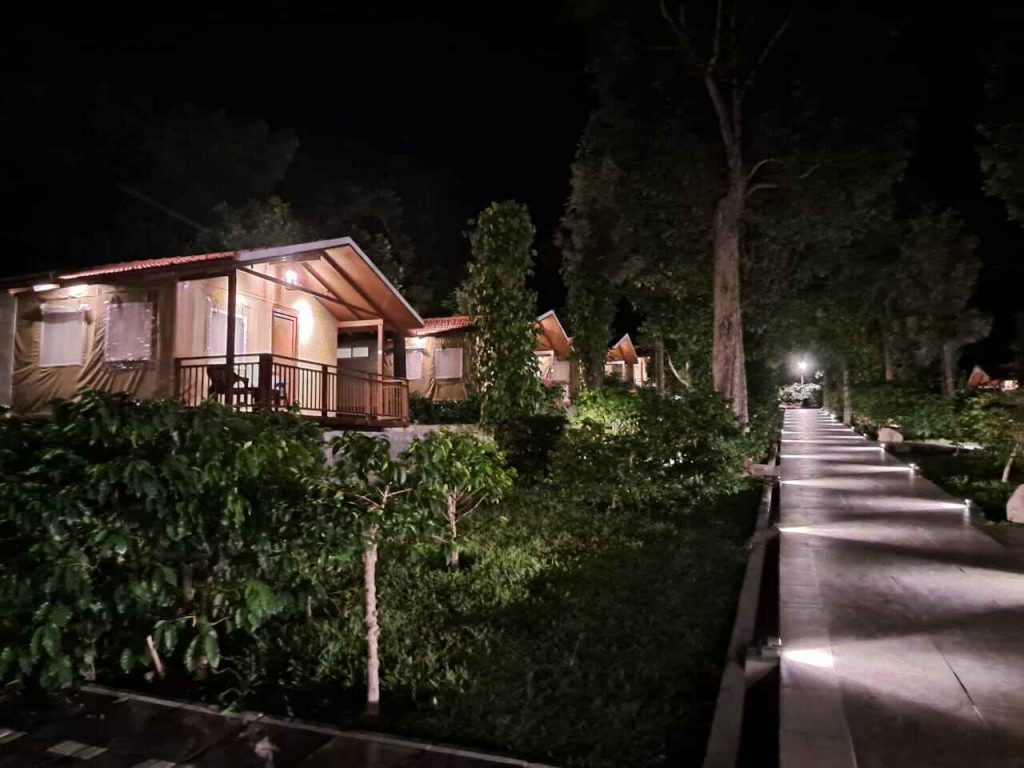 A charming cabin nestled in a winter landscape, surrounded by trees, getaway near Bangalore.