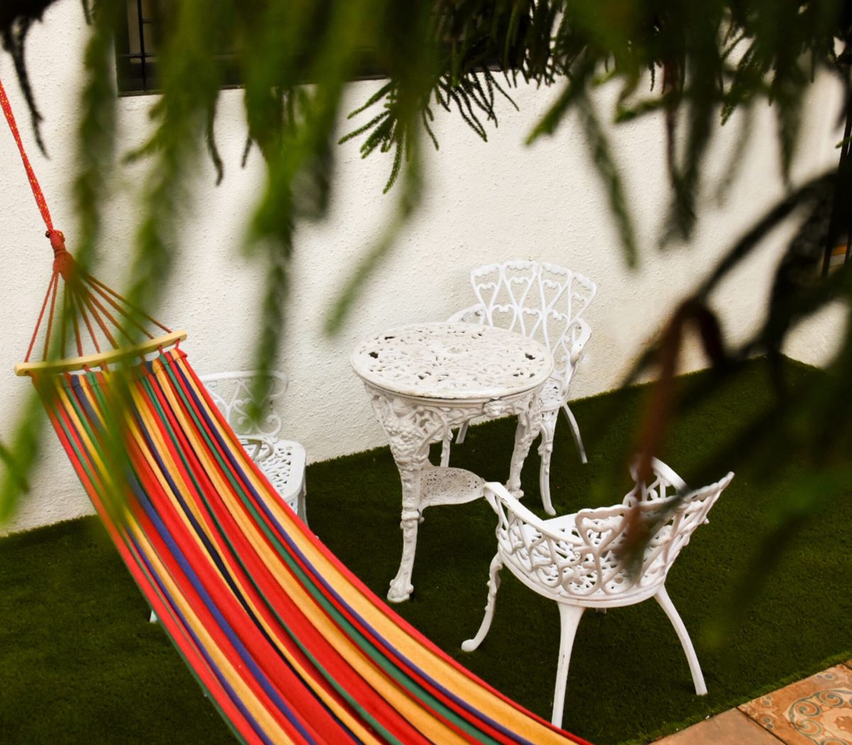 Privy Stays Reed Field Cottage Alibaug, Colonial style outdoor sitting area. Hammocks for ultimate lounging experience. 