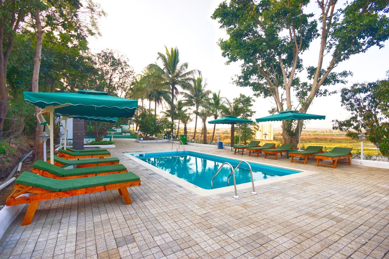 lounger-beside-pool-Best Resorts with activities in Igatpuri