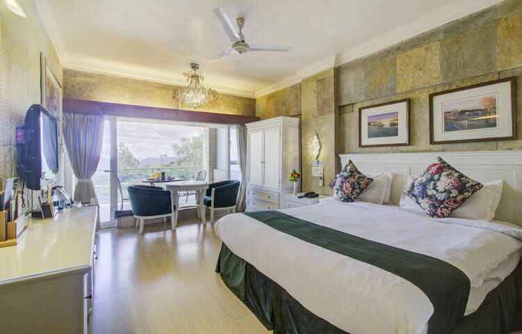 luxury hill getaway: resorts near Pune in Monsoon bedroom view