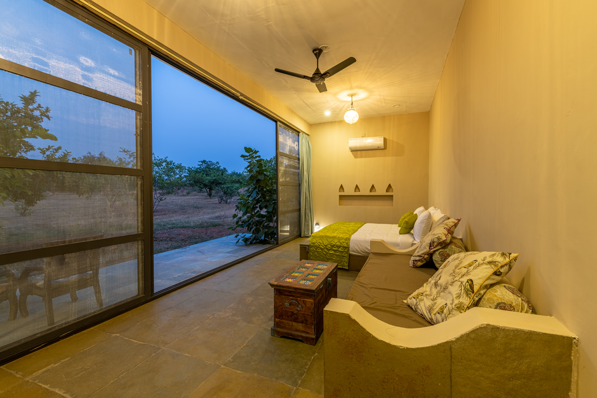 wilderness stay bedroom with lounging area view