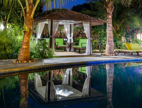 Sit out area by the pool at the Dreamy Cottages On An Island In Mulshi, perfect for hosting wedding events