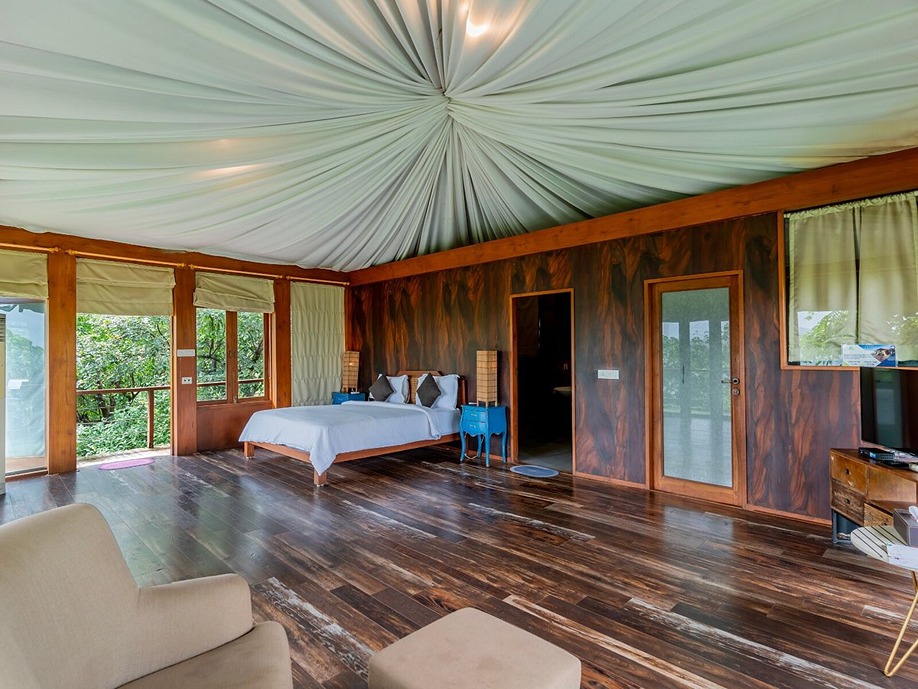 Luxurious bedroom at the Mountain View Hideaway in Tala, one of the best riverfront resorts near Mumbai