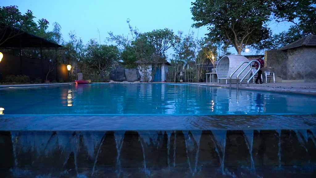 Outdoor swimming pool at the Boutique Farm Stay in Karjat.